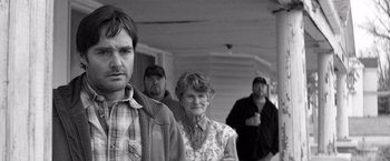 Movie still from “Nebraska” (2013), directed by Alexander Payne – A group of men and women standing in a room; Medium shot, Over the shoulder angle