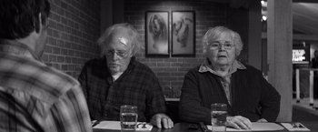 Movie still from “Nebraska” (2013), directed by Alexander Payne – A man and a woman sitting at a dinner table; Medium shot, High angle