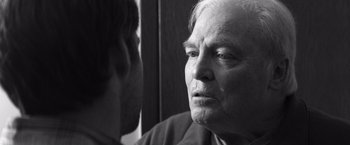 Movie still from “Nebraska” (2013), directed by Alexander Payne – An older man looking into a mirror while standing next to a younger man; Close Up shot, Over the shoulder angle