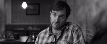 Movie still from “Nebraska” (2013), directed by Alexander Payne – Black and white photograph of a man in a plaid shirt; Close Up shot, Over the shoulder angle