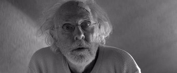 Movie still from “Nebraska” (2013), directed by Alexander Payne – An old man with a white beard wearing glasses; Close Up shot, Low angle