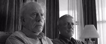 Movie still from “Nebraska” (2013), directed by Alexander Payne – Two older men sitting next to each other in front of a window; Close Up shot, Low angle