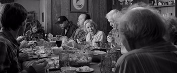 Movie still from “Nebraska” (2013), directed by Alexander Payne – A group of people sitting at a dinner table; Medium shot, High angle