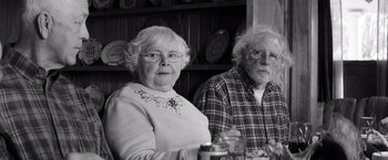 Movie still from “Nebraska” (2013), directed by Alexander Payne – An older couple sitting in front of a bookshelf; Medium shot, Over the shoulder angle