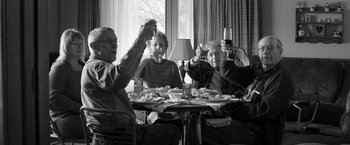 Movie still from “Nebraska” (2013), directed by Alexander Payne – A group of people sitting at a table with wine glasses; Medium shot, Low angle