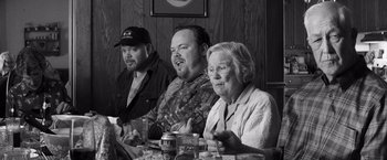 Movie still from “Nebraska” (2013), directed by Alexander Payne – A group of people sitting at a dinner table; Medium shot, Over the shoulder angle