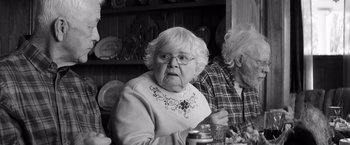 Movie still from “Nebraska” (2013), directed by Alexander Payne – An older woman sitting at a dinner table; Close Up shot, Over the shoulder angle