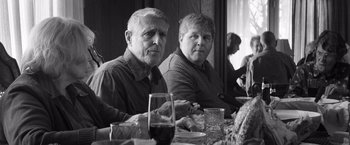 Movie still from “Nebraska” (2013), directed by Alexander Payne – Two people sitting at a dinner table with wine glasses; Medium shot, Over the shoulder angle