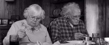 Movie still from “Nebraska” (2013), directed by Alexander Payne – An older man and woman sitting at a dinner table; Close Up shot, High angle