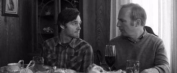 Movie still from “Nebraska” (2013), directed by Alexander Payne – Two men are sitting at a table with a glass of red wine; Close Up shot, Over the shoulder angle