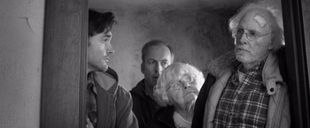 Movie still from “Nebraska” (2013), directed by Alexander Payne – A group of people standing next to each other in a room; Close Up shot, Low angle