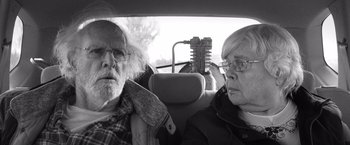 Movie still from “Nebraska” (2013), directed by Alexander Payne – A man and a woman sitting in the back of a car; Close Up shot, Over the shoulder angle