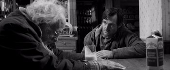 Movie still from “Nebraska” (2013), directed by Alexander Payne – A man sitting at a table with another man; Close Up shot, Over the shoulder angle