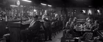 Movie still from “Nebraska” (2013), directed by Alexander Payne – An older man standing in front of a group of people; Wide shot, Over the shoulder angle