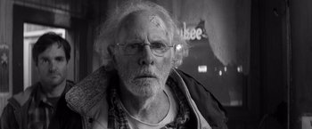 Movie still from “Nebraska” (2013), directed by Alexander Payne – An old man with a white beard wearing glasses; Close Up shot, Over the shoulder angle
