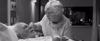 Movie still from “Nebraska” (2013), directed by Alexander Payne – An older woman sitting at a table with a stuffed animal; Close Up shot, Over the shoulder angle