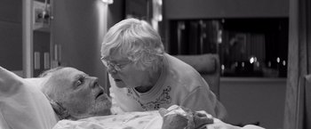 Movie still from “Nebraska” (2013), directed by Alexander Payne – An older woman sitting at a table with a stuffed animal; Close Up shot, Over the shoulder angle