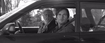 Movie still from “Nebraska” (2013), directed by Alexander Payne – A man and a woman sitting in the back seat of a car; Close Up shot, Over the shoulder angle