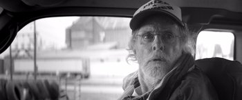 Movie still from “Nebraska” (2013), directed by Alexander Payne – An old man with a beard wearing glasses and a hat; Close Up shot, Low angle