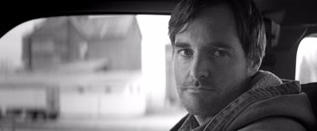 Movie still from “Nebraska” (2013), directed by Alexander Payne – Black and white photograph of a man in a car; Close Up shot, Low angle