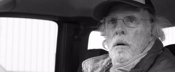 Movie still from “Nebraska” (2013), directed by Alexander Payne – An old man with a beard and a hat in a car; Close Up shot, Over the shoulder angle