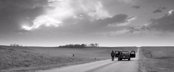 Movie still from “Nebraska” (2013), directed by Alexander Payne – Two people are standing on the side of the road; Extreme Wide shot, Low angle