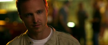 Movie still from “Need for Speed” (2014), directed by Scott Waugh – A person wearing a white t - shirt; Close Up shot, Over the shoulder angle