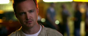 Movie still from “Need for Speed” (2014), directed by Scott Waugh – A person wearing a white t - shirt; Close Up shot, Over the shoulder angle