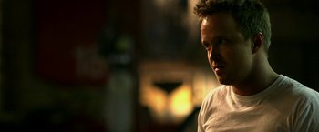 Movie still from “Need for Speed” (2014), directed by Scott Waugh – A person wearing a white t - shirt; Close Up shot, Over the shoulder angle