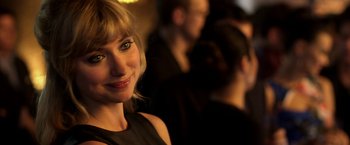 Movie still from “Need for Speed” (2014), directed by Scott Waugh – A woman smiling for the camera; Close Up shot, Over the shoulder angle