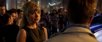 Movie still from “Need for Speed” (2014), directed by Scott Waugh – A person with a crowd in the background; Close Up shot, Over the shoulder angle