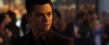 Movie still from “Need for Speed” (2014), directed by Scott Waugh – A person wearing a suit and tie; Close Up shot, Over the shoulder angle