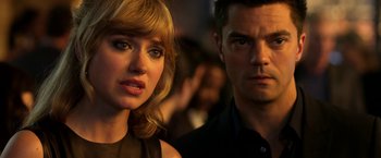 Movie still from “Need for Speed” (2014), directed by Scott Waugh – A man and a woman standing next to each other; Close Up shot, Over the shoulder angle