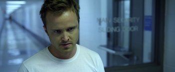 Movie still from “Need for Speed” (2014), directed by Scott Waugh – A person wearing a white t - shirt; Close Up shot, Over the shoulder angle