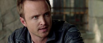 Movie still from “Need for Speed” (2014), directed by Scott Waugh – A person wearing a leather jacket; Close Up shot, Over the shoulder angle