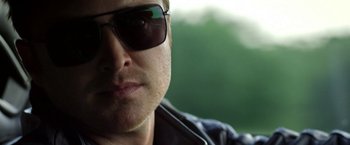 Movie still from “Need for Speed” (2014), directed by Scott Waugh – A person wearing sunglasses; Close Up shot, Over the shoulder angle