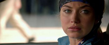 Movie still from “Need for Speed” (2014), directed by Scott Waugh – A woman's face with a bandanna around her head; Close Up shot, Over the shoulder angle