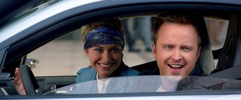 Movie still from “Need for Speed” (2014), directed by Scott Waugh – A man and a woman sitting in the back of a car; Close Up shot, Over the shoulder angle