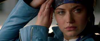 Movie still from “Need for Speed” (2014), directed by Scott Waugh – A woman's face with her hands on her head; Close Up shot, Overhead angle