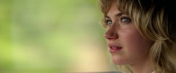 Movie still from “Need for Speed” (2014), directed by Scott Waugh – A woman's face with a green background; Close Up shot, Over the shoulder angle