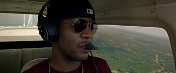 Movie still from “Need for Speed” (2014), directed by Scott Waugh – A person in a helicopter; Close Up shot, Overhead angle