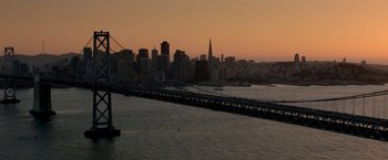Movie still from “Need for Speed” (2014), directed by Scott Waugh – A view of a city skyline at sunset; Extreme Wide shot, High angle