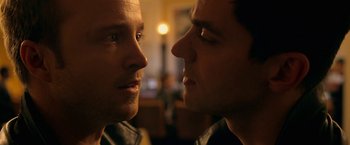 Movie still from “Need for Speed” (2014), directed by Scott Waugh – Two men looking into each other's eyes in a room; Close Up shot, Over the shoulder angle