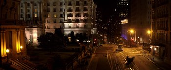 Movie still from “Need for Speed” (2014), directed by Scott Waugh – A city street at night lit up by street lights; Extreme Wide shot, High angle