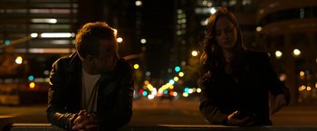 Movie still from “Need for Speed” (2014), directed by Scott Waugh – A man and a woman sitting on a bench at night; Medium shot, Over the shoulder angle