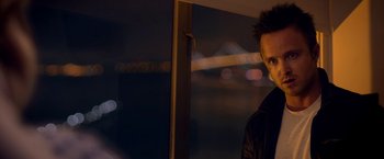Movie still from “Need for Speed” (2014), directed by Scott Waugh – A man standing in front of a window at night; Close Up shot, Over the shoulder angle