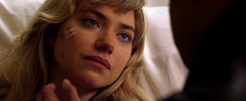 Movie still from “Need for Speed” (2014), directed by Scott Waugh – A person with a bandage on their face; Close Up shot, Over the shoulder angle