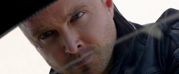 Movie still from “Need for Speed” (2014), directed by Scott Waugh – A man's face with green eyes; Extreme Close Up shot, Over the shoulder angle