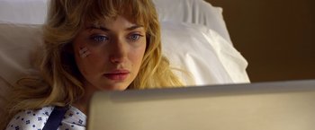Movie still from “Need for Speed” (2014), directed by Scott Waugh – A woman looking at a laptop computer in bed; Close Up shot, Over the shoulder angle