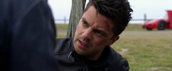 Movie still from “Need for Speed” (2014), directed by Scott Waugh – A person wearing a leather jacket; Close Up shot, Over the shoulder angle